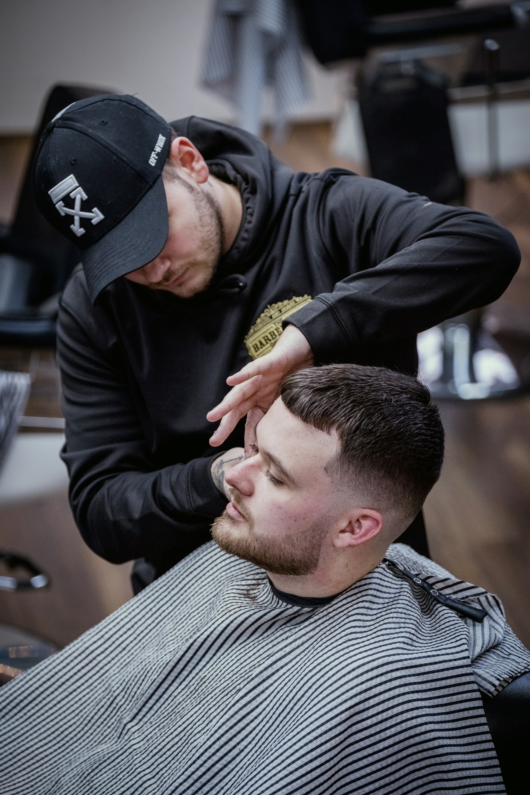 Barber finishing a client’s haircut